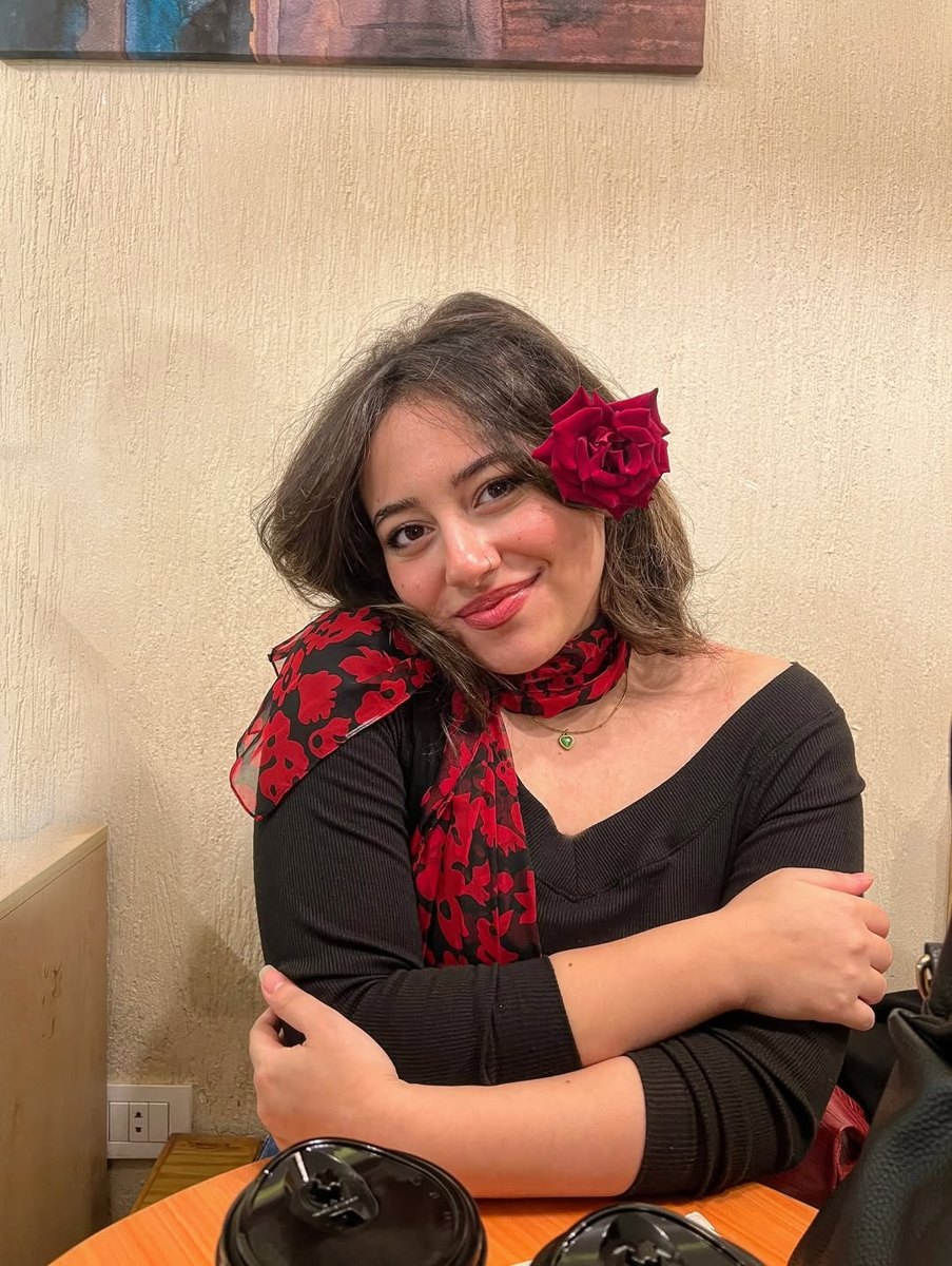 Shoruk wearing a red flower in her hair